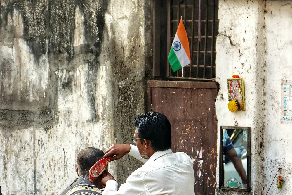 A barber at work in his own roadside shop