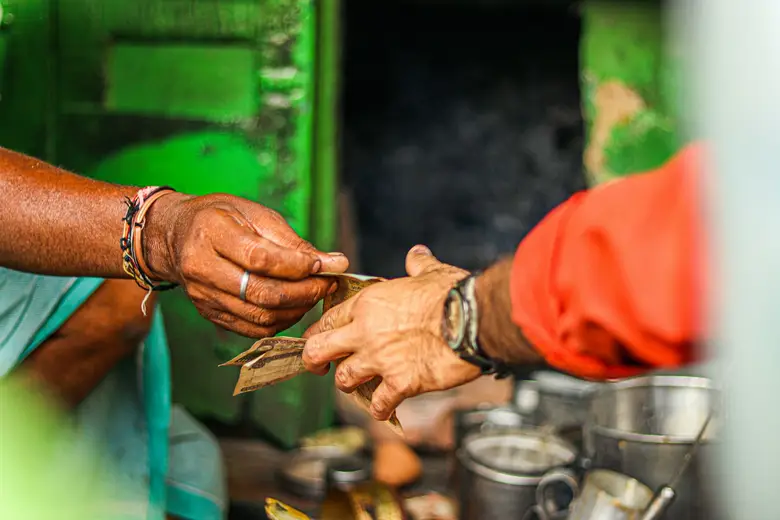 Money being counted out by hand at a stall