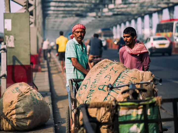 Handcart pullers on a busy road